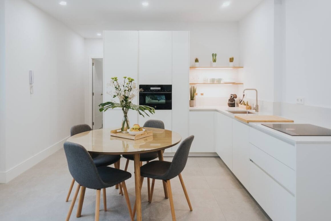 Modern, white kitchen and dining area