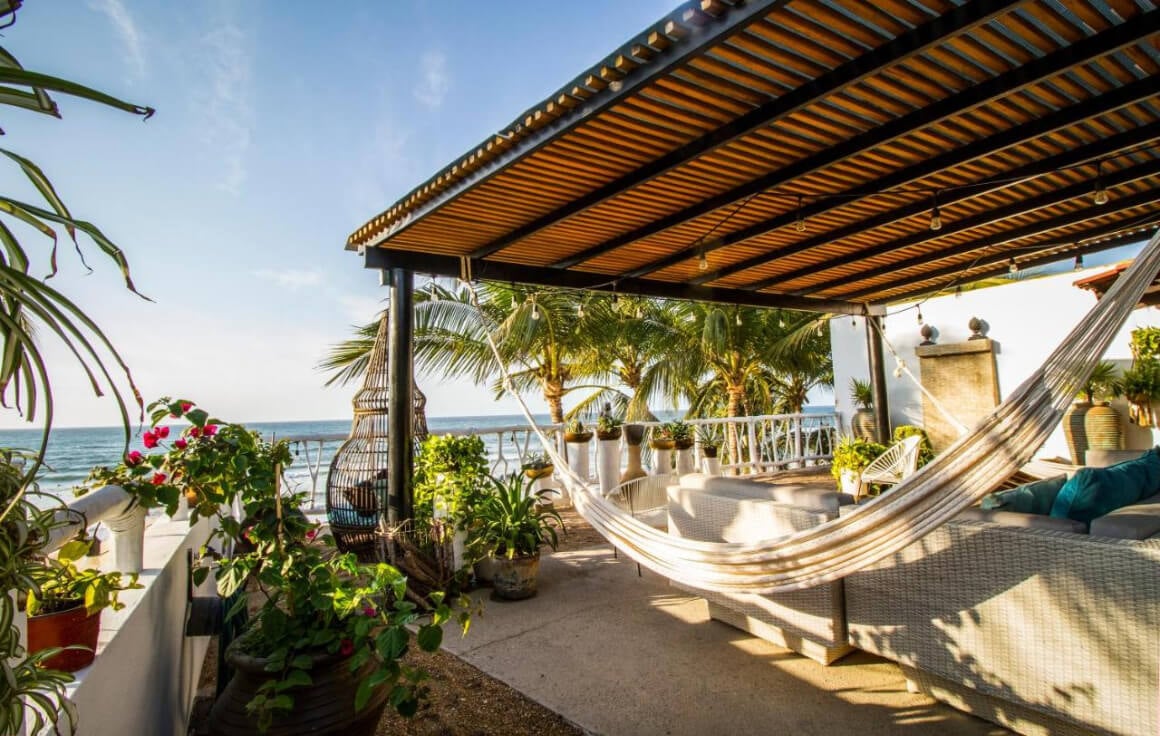 Hotel Vista Oceana's patio space with a hammock and lush greenery 