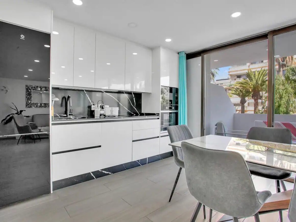 Modern kitchen and dining area with sliding doors to outdoor terrace