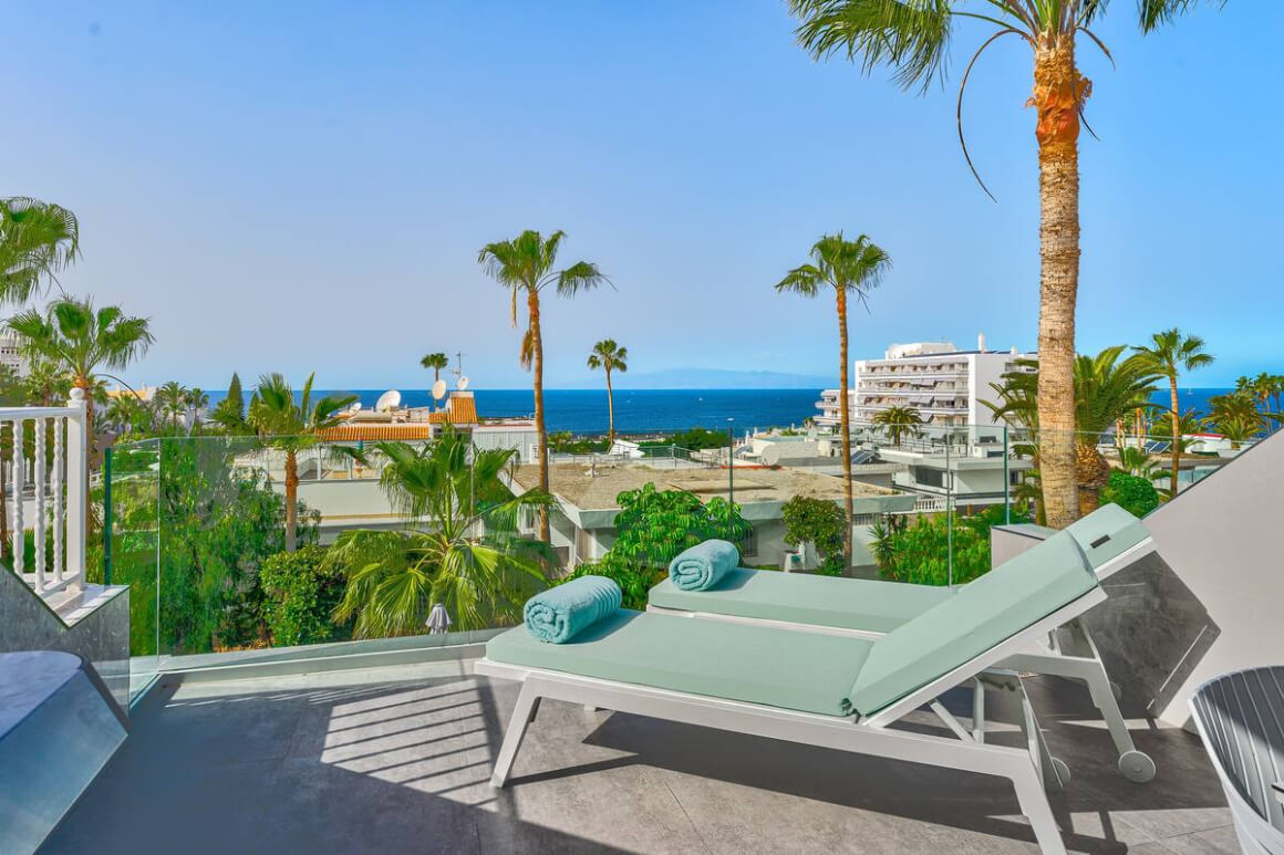 Loungers on the terrace looking out over the city and toward the ocean