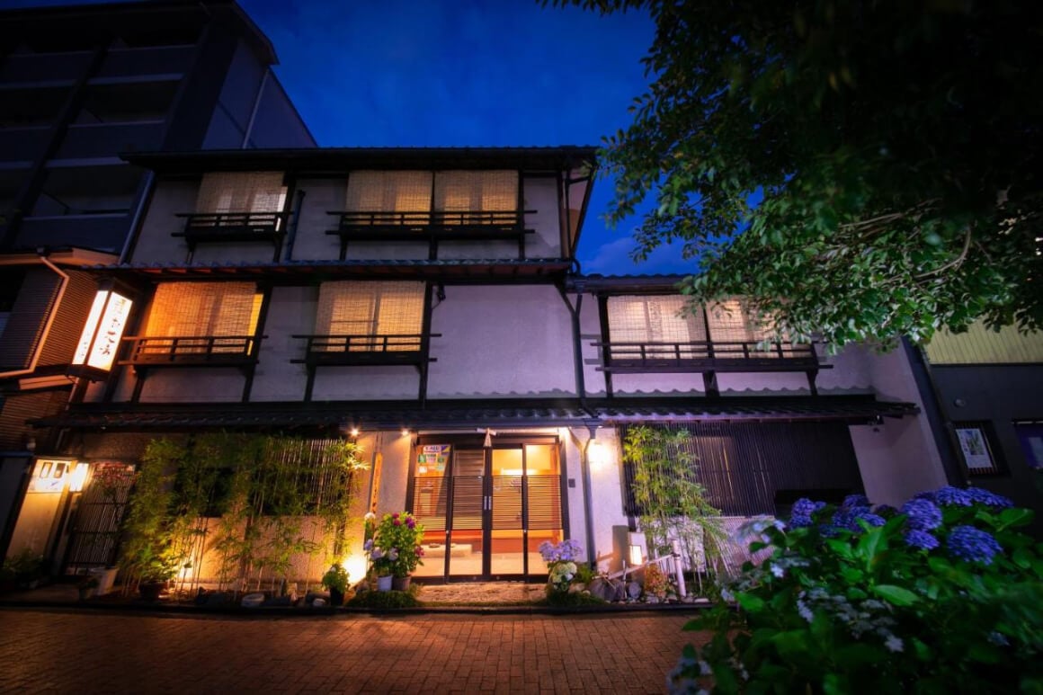 The front of a traditional Japanese Ryokan building (Ohanabo) at night softly lit