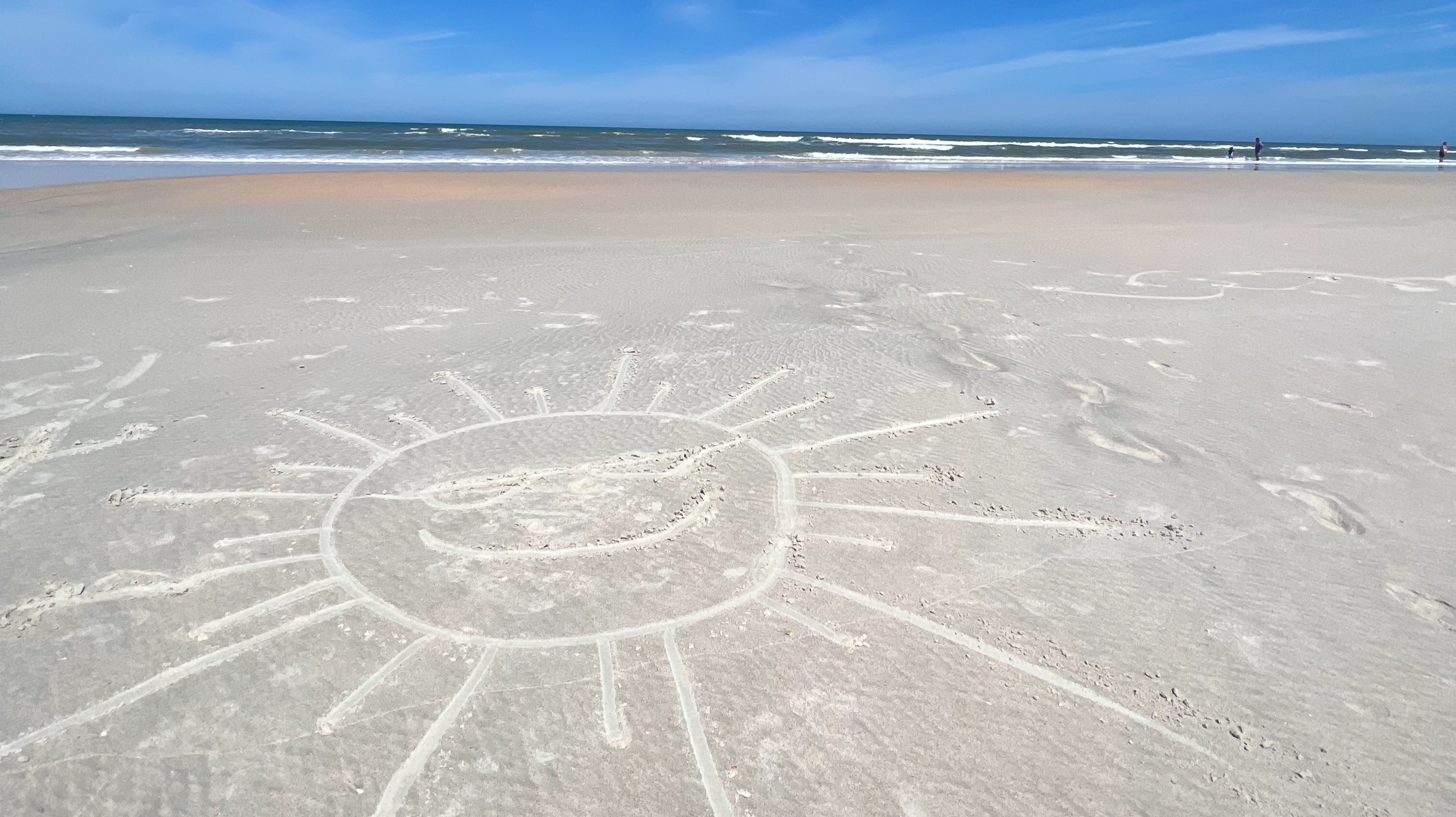 a sun created as art in the sand at a beach in St Augustine Florida
