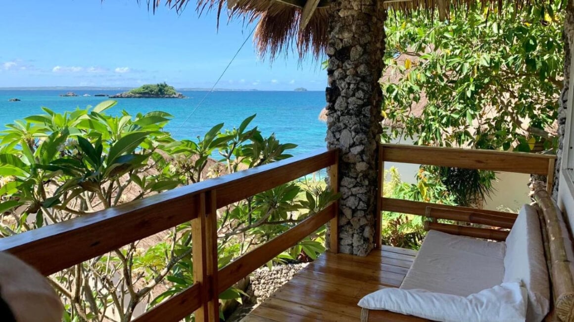 Ocean view from the balcony surrounded with trees at Tepanee Beach Resort.