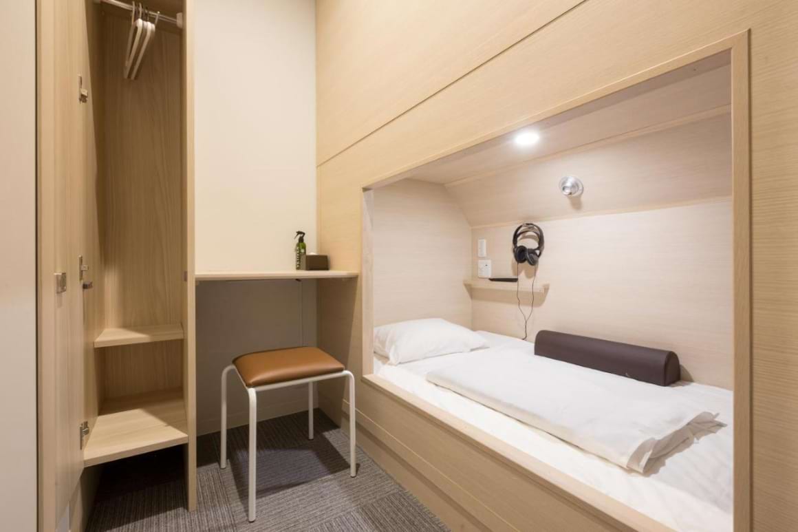 A small room with a bunk bed, storage space and a built-in desk in Grand Cabin Tenjin Minami