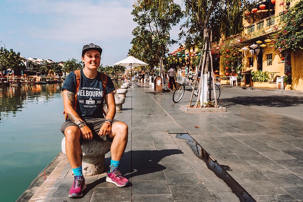 A person sitting next to the river in Hoi An, Vietnam