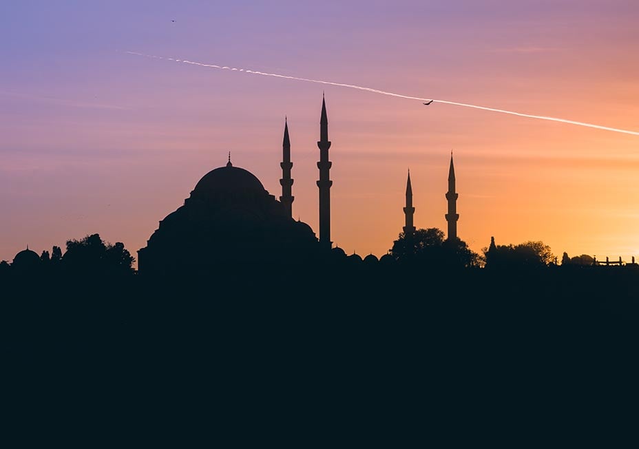 The sunsetting behind the minarets of a large Mosque in Istanbul, Turkey