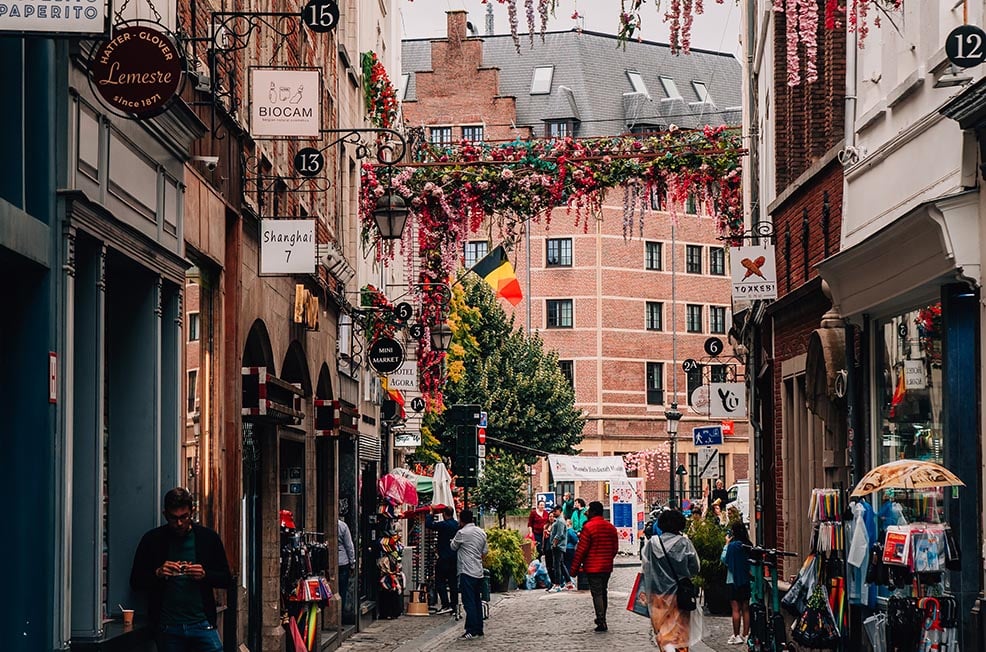 A street in Brussels, Belgium with ornate flowers hanging across it