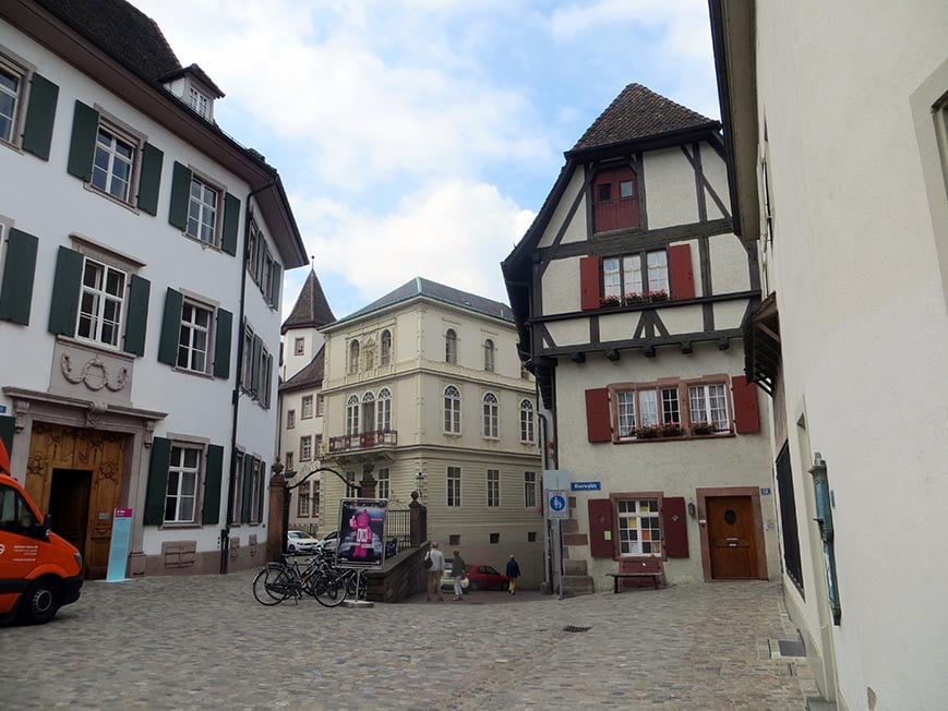 A quaint side street with wooden panel buildings in Basel, Switzerland