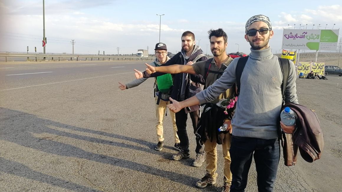 a group of backpackers hitching a ride in iran