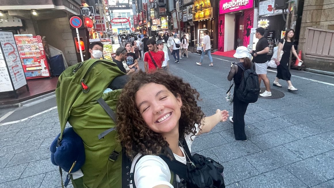 Girl smiles for a photo in the streets of Tokyo.