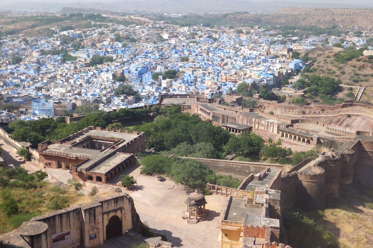 india's blue city jodhpur seen from a fort above it on a sunny afternoon
