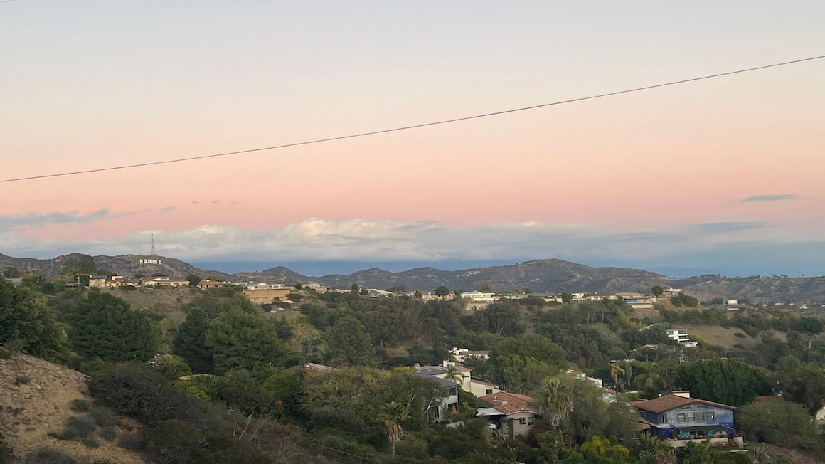 hollywood sign under a pink sunset as sign from a hiking trail in los angeles california usa