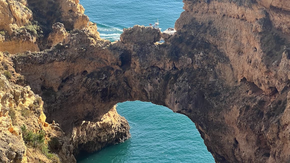 a cliff in the shape of an arch in lagos, portugal