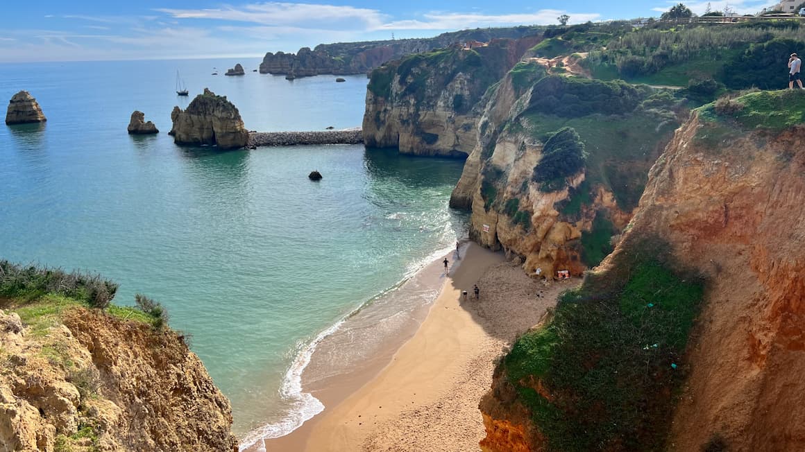 cliffs and the blue ocean on a sunny day in lagos, portugal