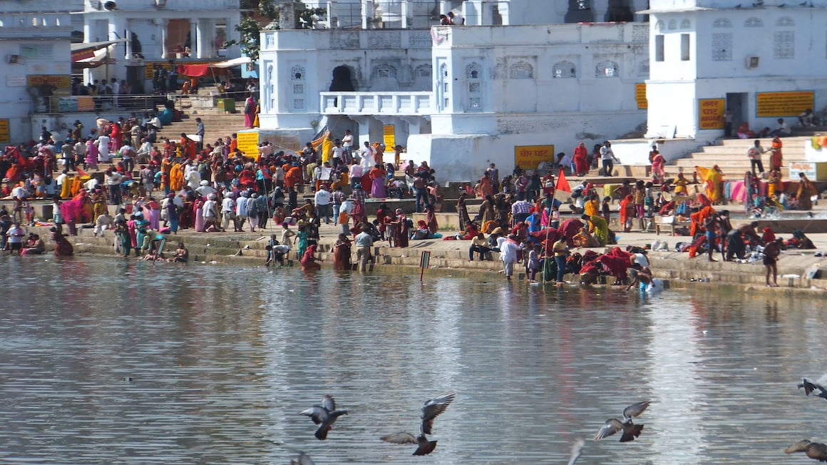 locals bathing in a lake in pushkar in rajasthan india
