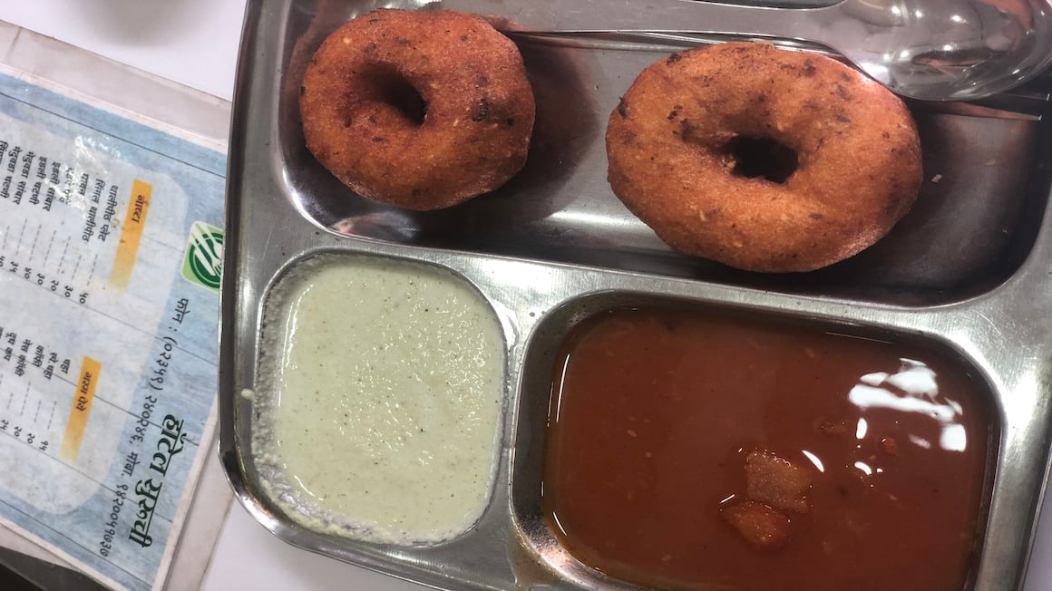 a thali of coconut sauce chutney and idli in south india