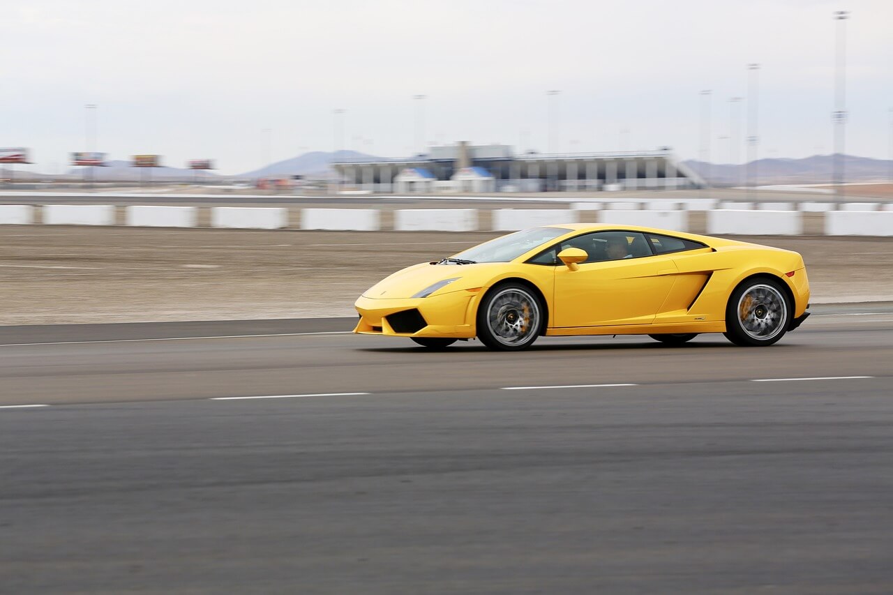 A yellow Lamborghini Gallardo racing on a track in Las Vegas 