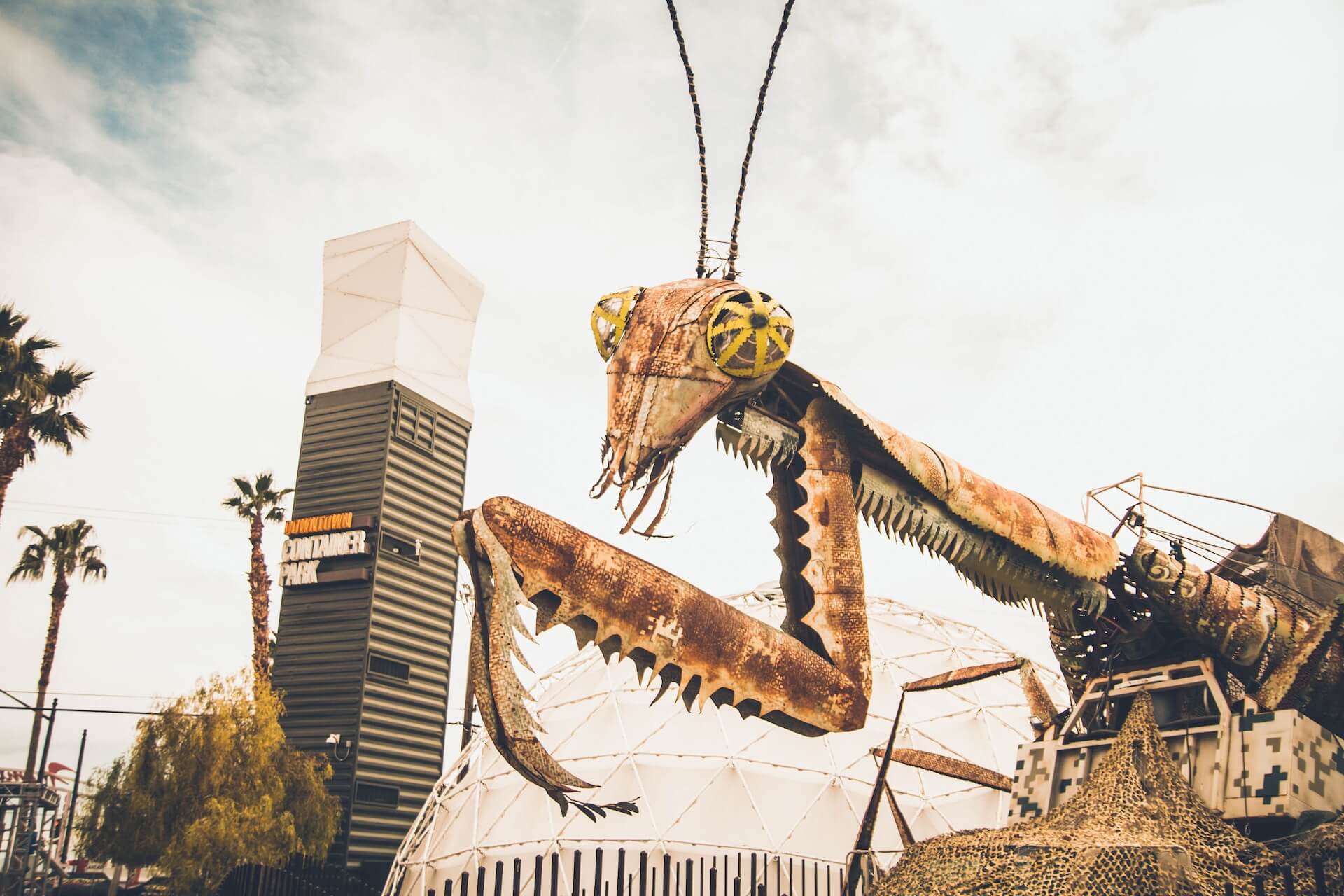 A large metal praying mantis statue in the Container Shops