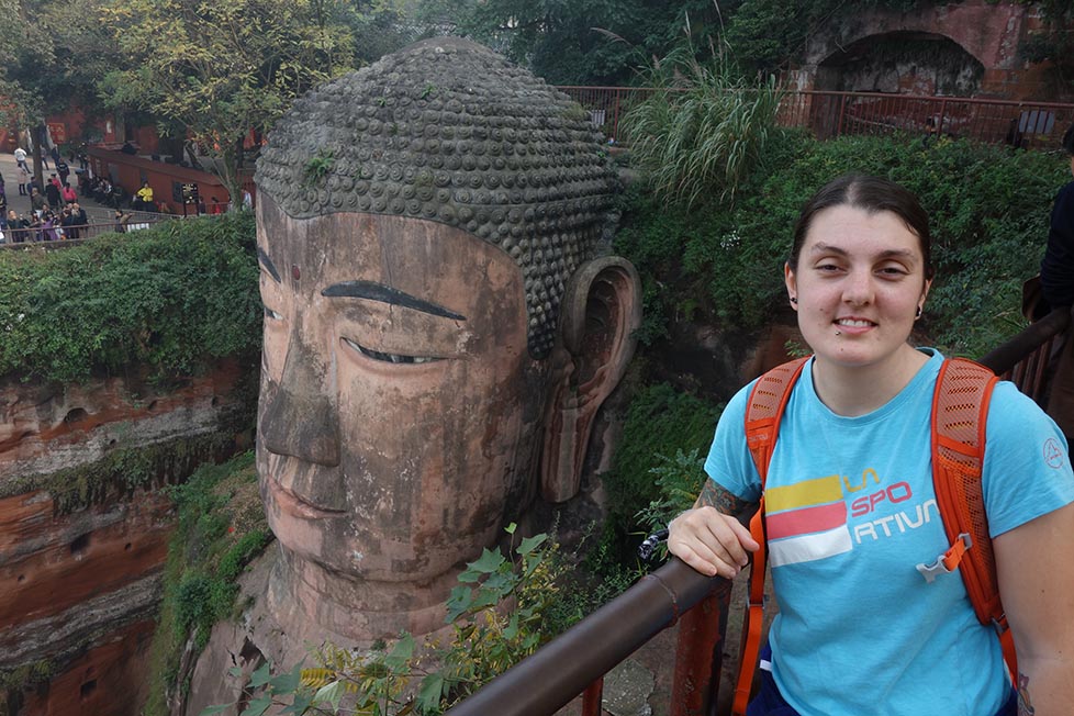 Nic standing next to the giant Leshan Buddha near Chengdu, China
