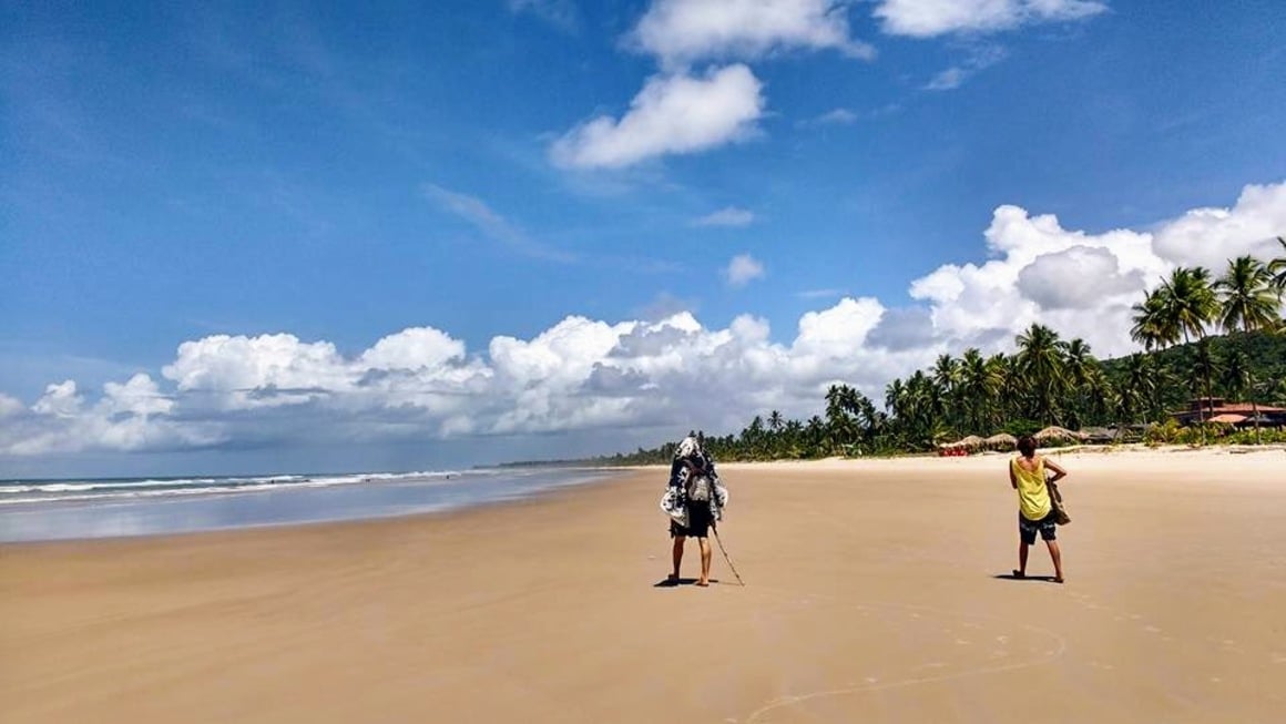 People walking on a long beach in Brazil.