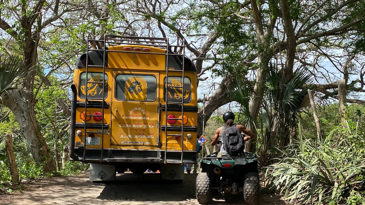 a yellow chicken bus for transportation in  Nicaragua, Central America and an ATV
