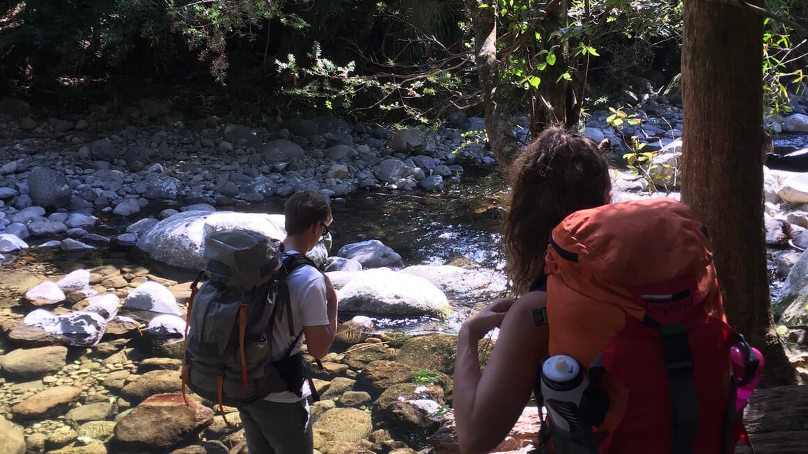 two friends hiking with backpacks