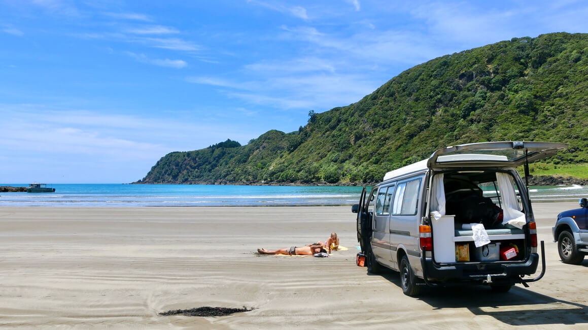 van parked up on a beach in New Zealand