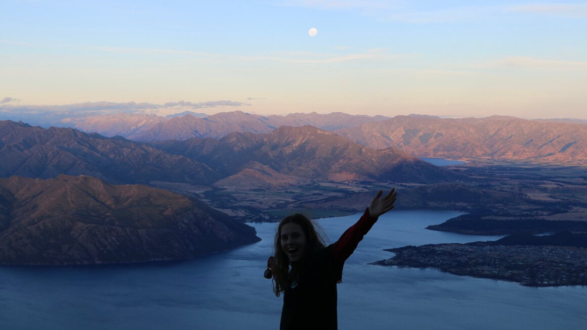 Danielle at the top of Roys Peak in New Zealand at sunset