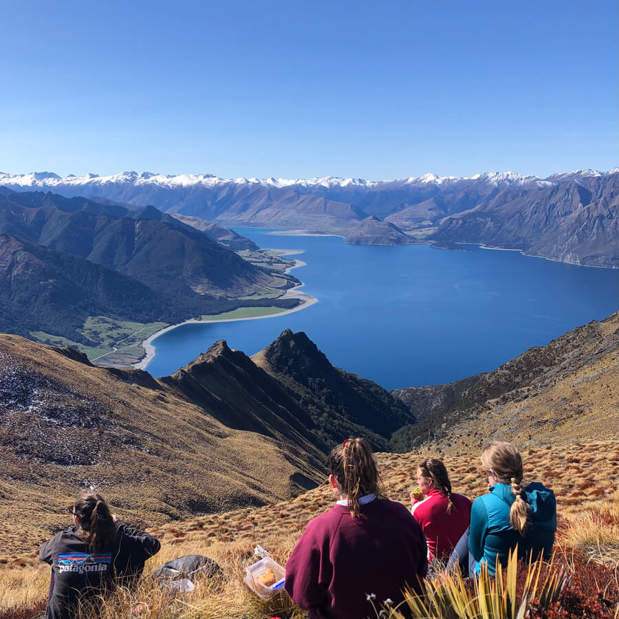 Friends enjoying lunch at the top of Isthmus Peak