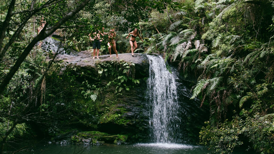 danielle and friends jumping off waterfall in new zealand