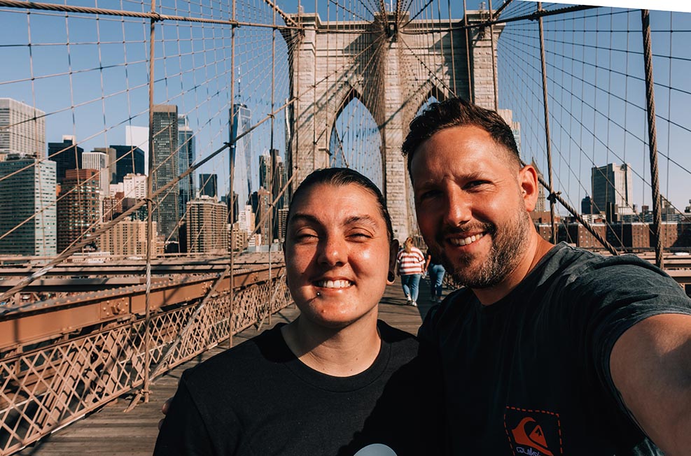 Nic and Shorty taking a selfie on the Brooklyn Bridge, New York, USA.