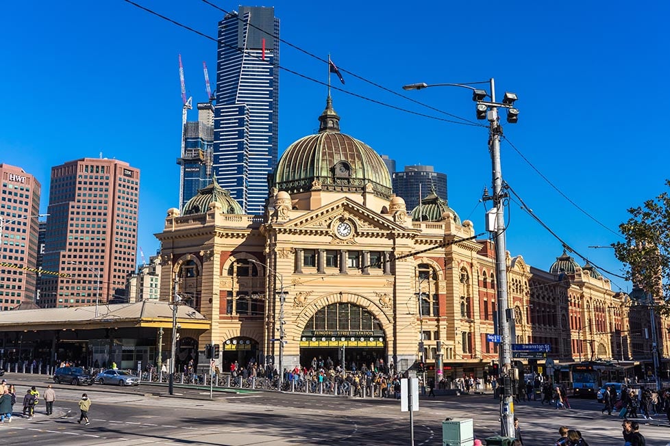 The outside of Flinders St Station with the Eureka Tower behind in Melbourne, Australia. .