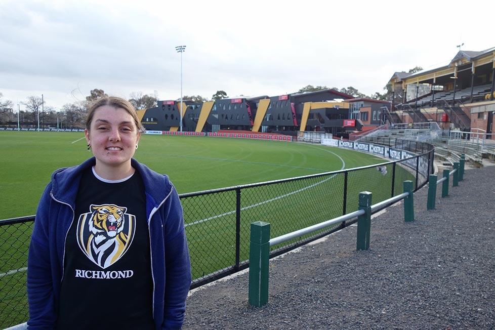 A person standing in front of the Punt Road Oval, Australia football ground, Richmond, Melbourne,