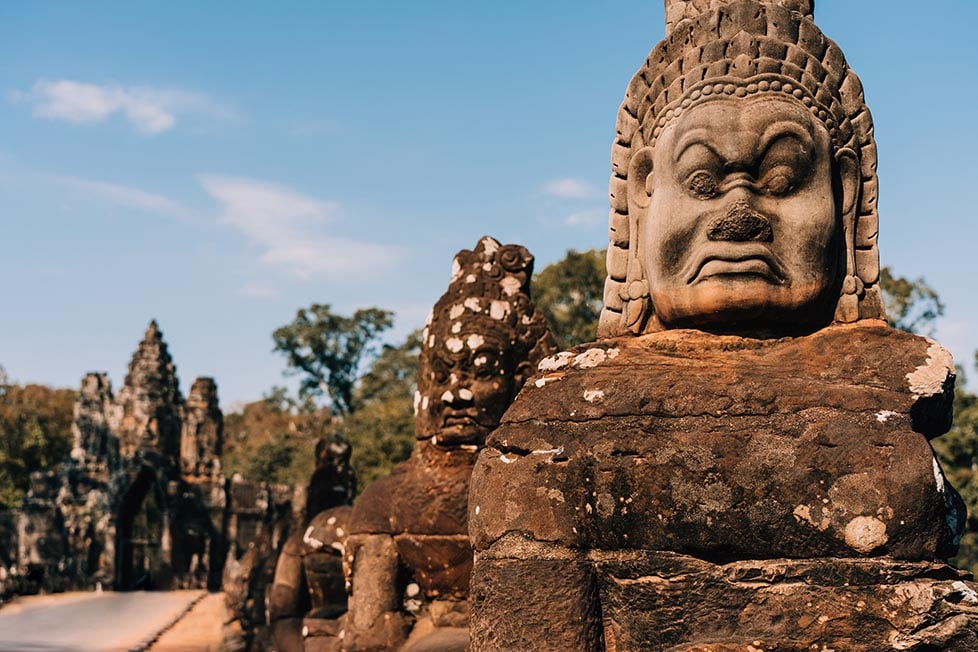 Carved faced on the temples of Angkor Wat, Cambodia in Southeast Asia.