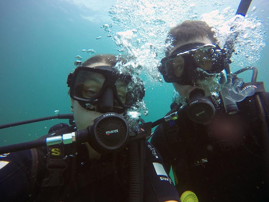 Two people taking a selfie whilst scuba diving.