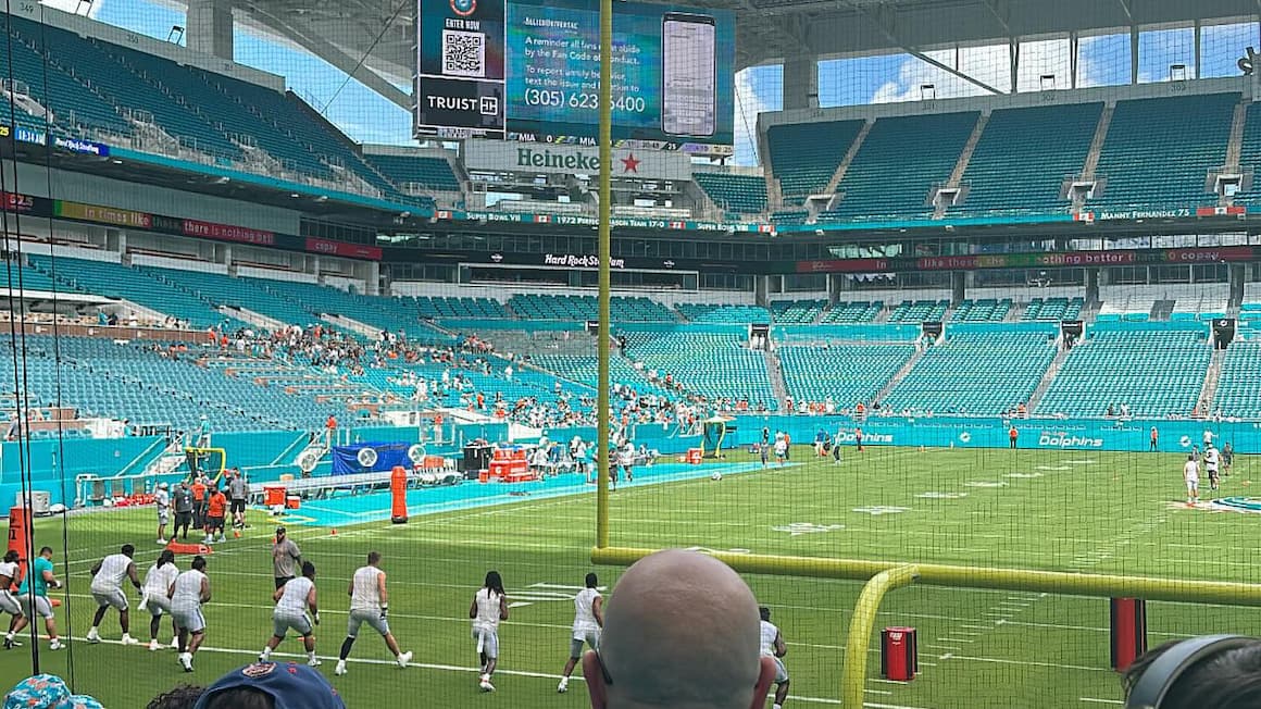 football players play a game of american football at the miami dolphin's stadium