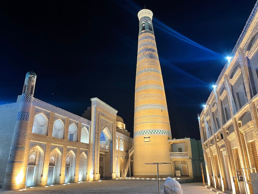 a historical minaret at a mosque in uzbekistan at night