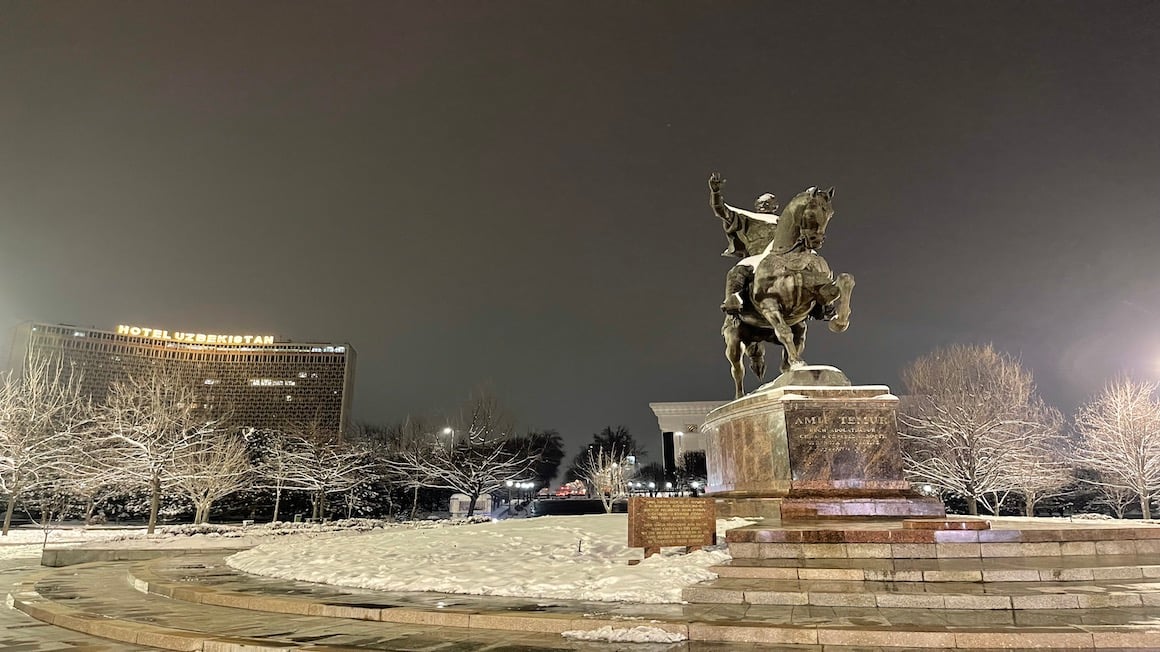 a monument in tashkent uzbekistan seen at night in winter with snow