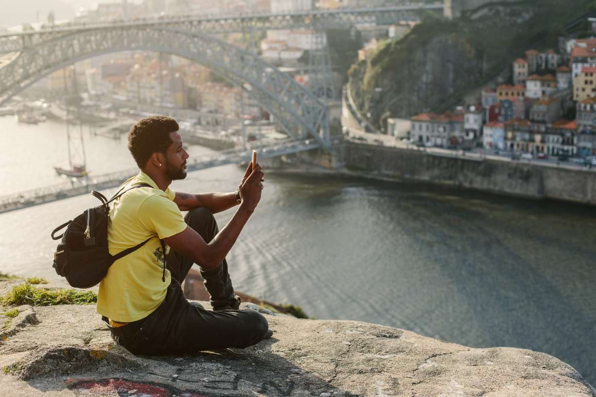 porto traveler man doing photo on mobile phone