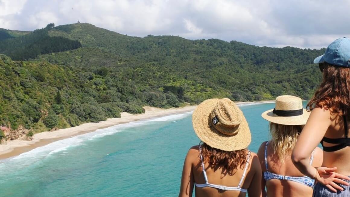 dani and friends at new chums beach in the coromandel, new zealand