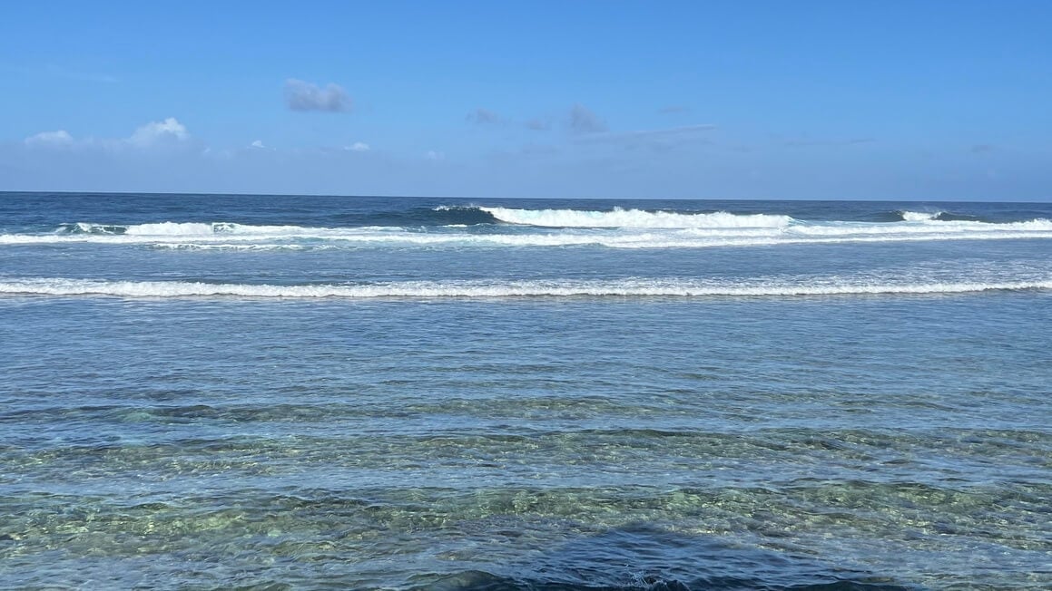 crystal clear ocean with small rolling waves