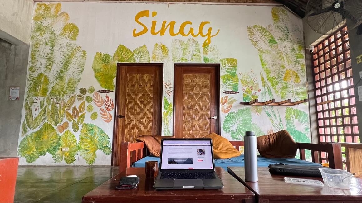 Digital nomad in Sinag Hostel coworking area Siargao, Philippines. Laptop and remote work.