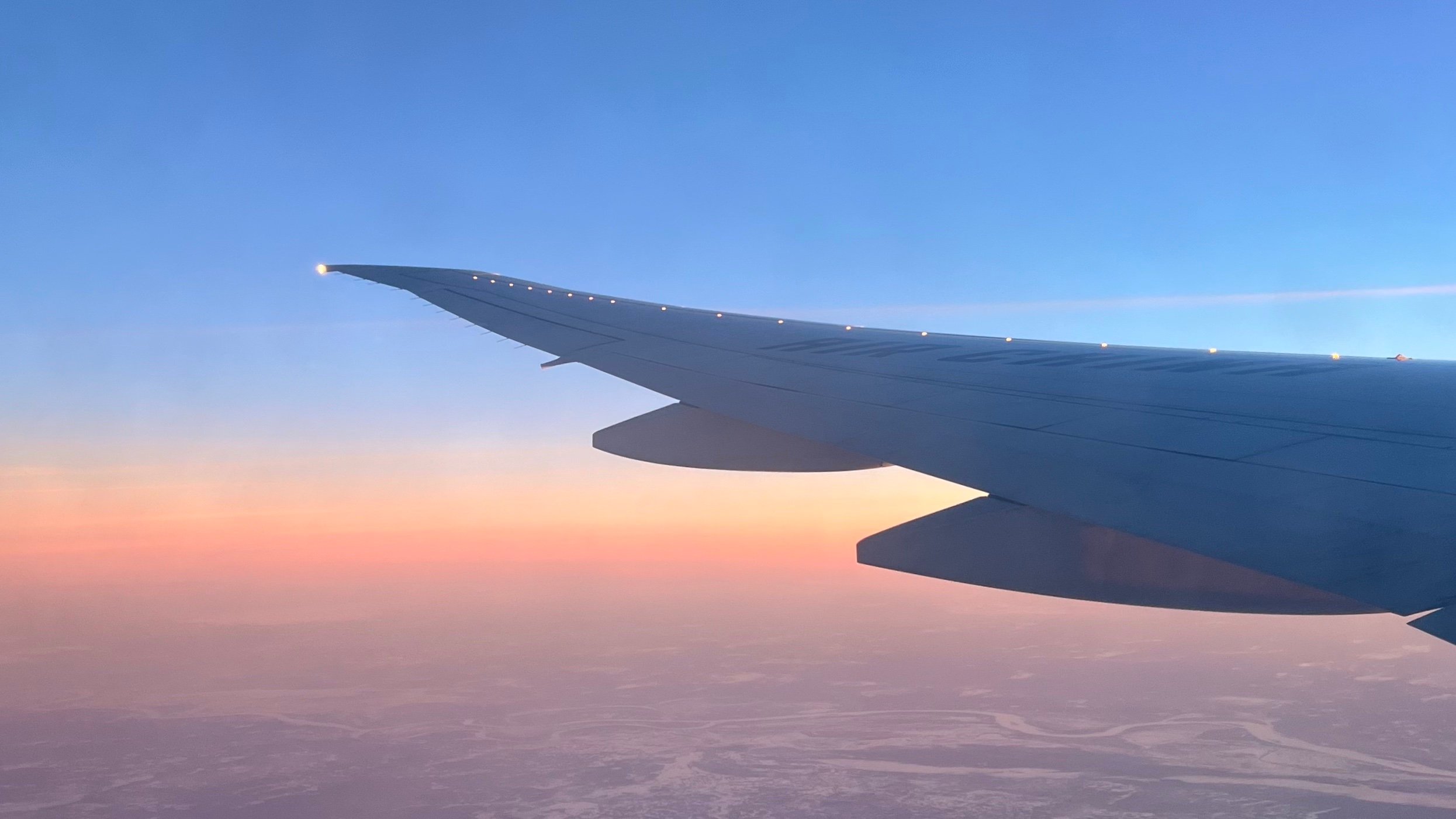 Plane wing at sunset