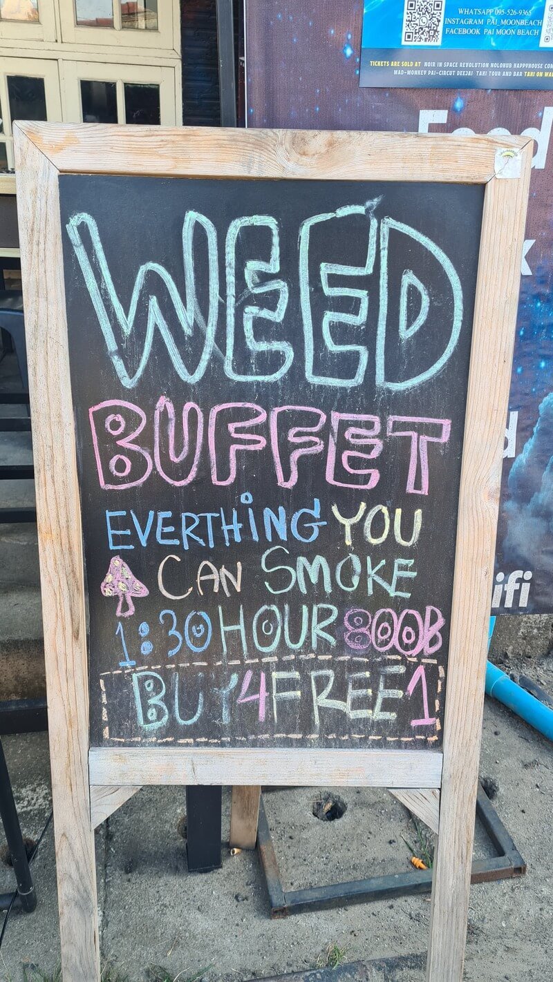 A frame chalk board advertising an everything you can smoke weed buffet for 800 Thai Bhat