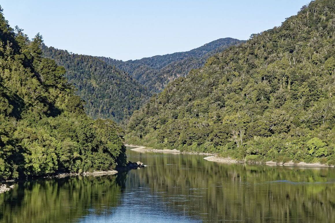 Bullet river flowing through a lush green forest valley.