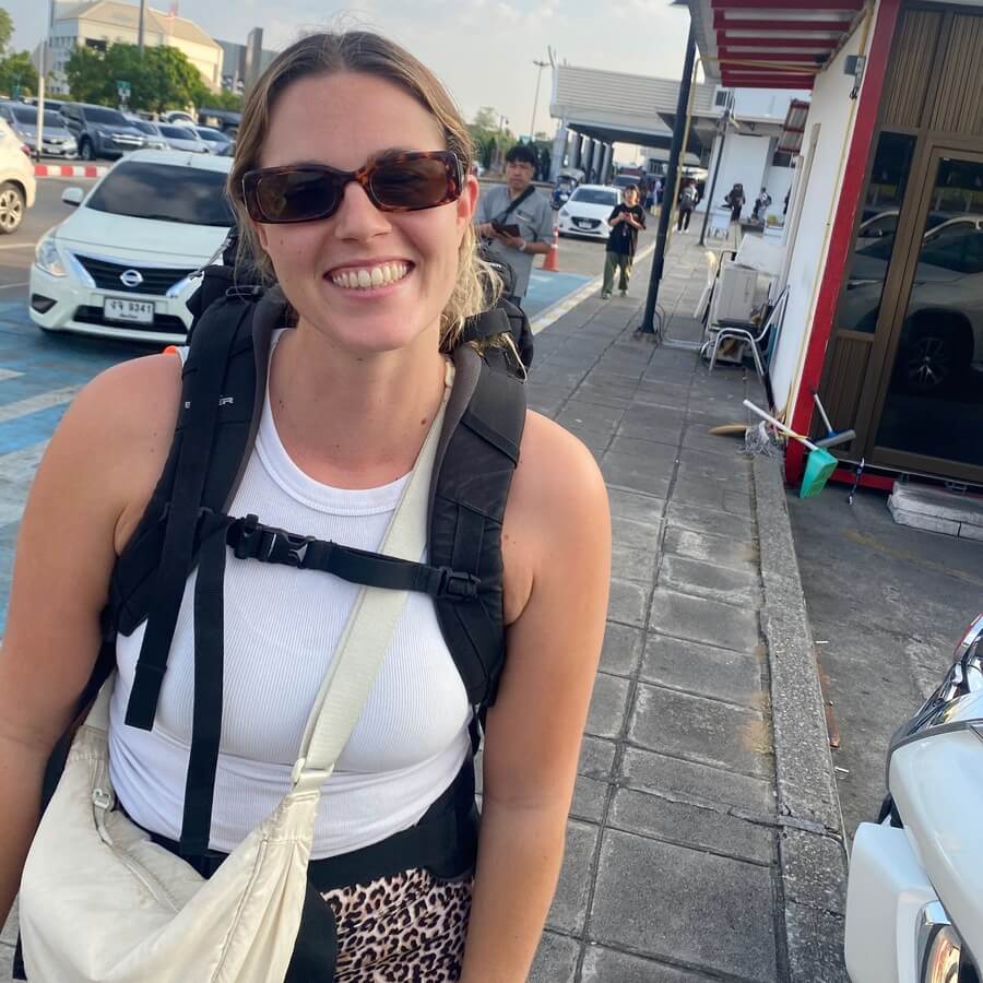 Dani with her backpack on waiting at the airport.