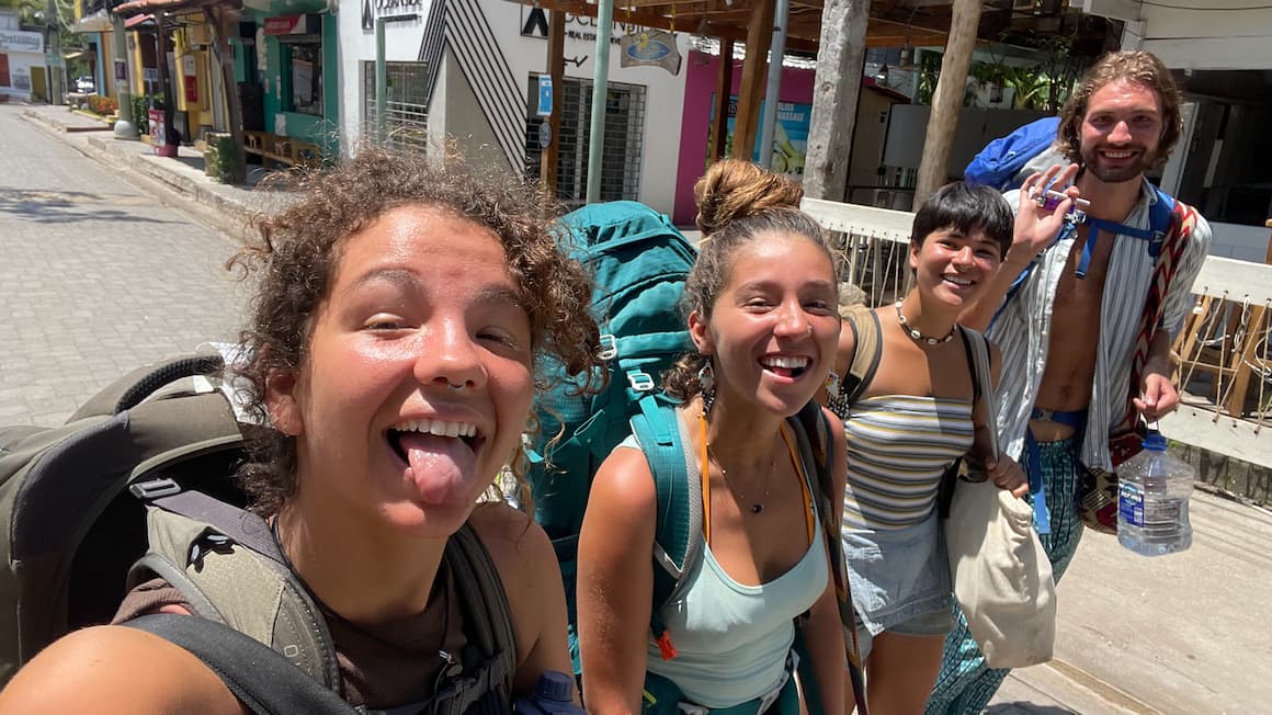 four friends walking through the streets of El Salvador with backpacks on