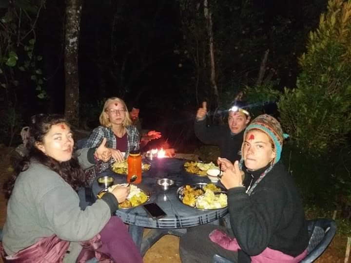 Group of ladies eating Nepali dinner in the dark