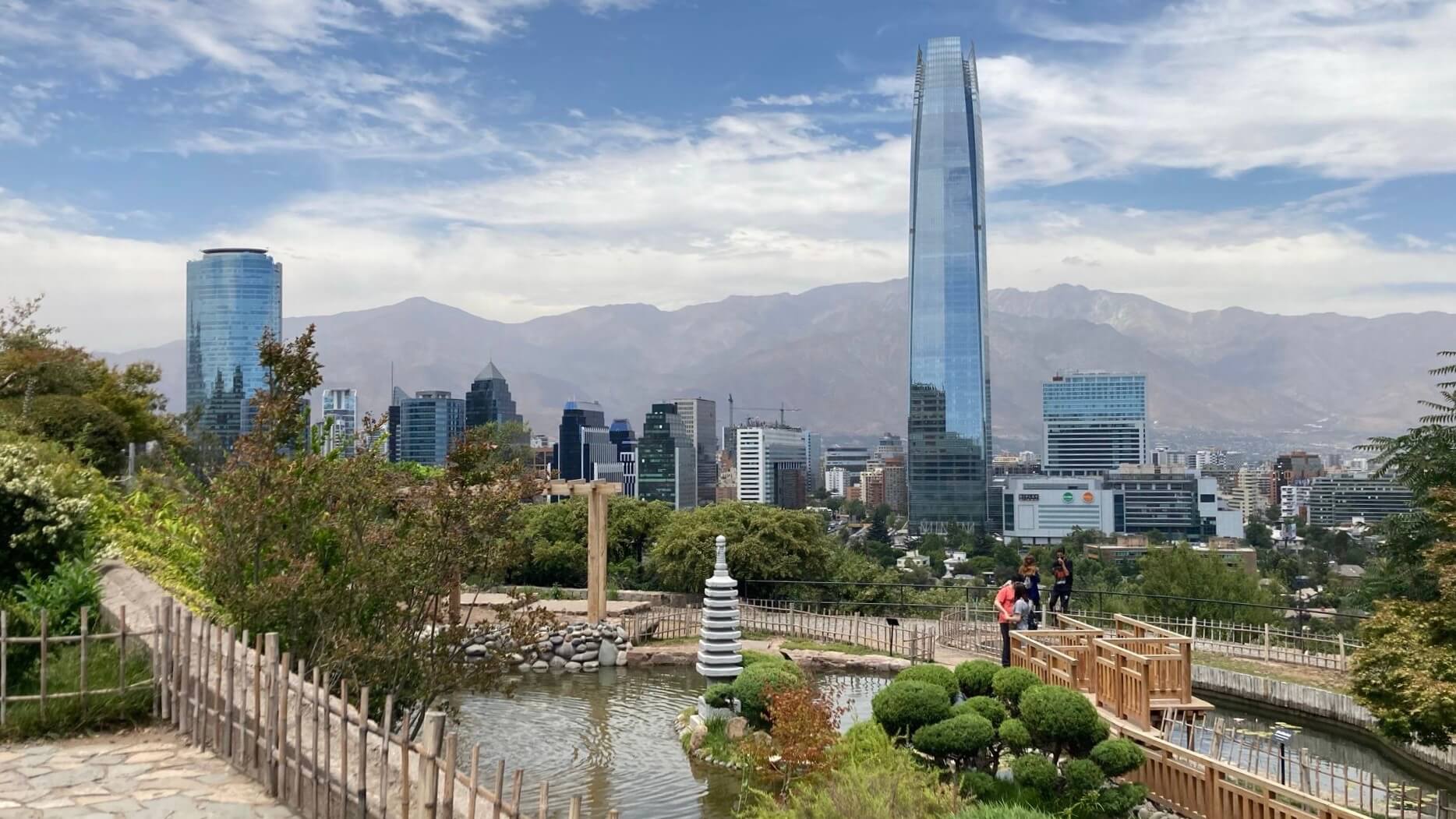 Santiago, Chile cityscape with a pond and green area in the foreground
