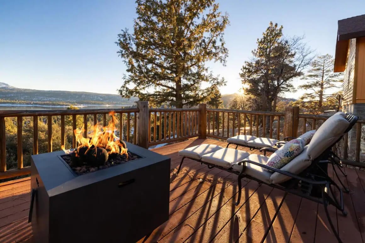 Outdoor fire on the deck at Lakeviews Lookout, Big Bear CA, sunny afternoon with loungers to relax on and wonder at the view of the forest and lake